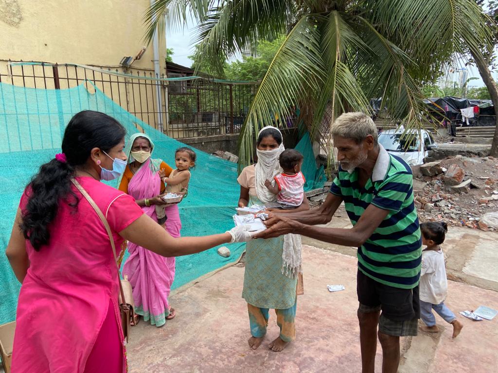 Welfare Activity- Distribution of food in the Slums.