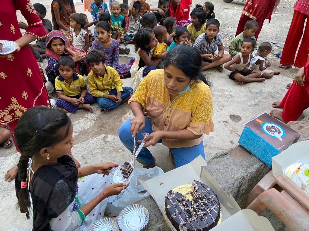 Welfare Activity - Distribution of cakes in the slums.
